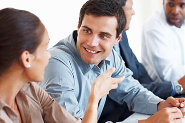 man engaging in conversation with a woman