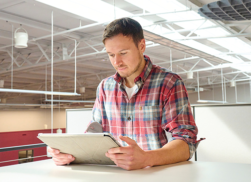 man reading on tablet