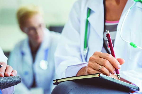 Doctors writing in notepads